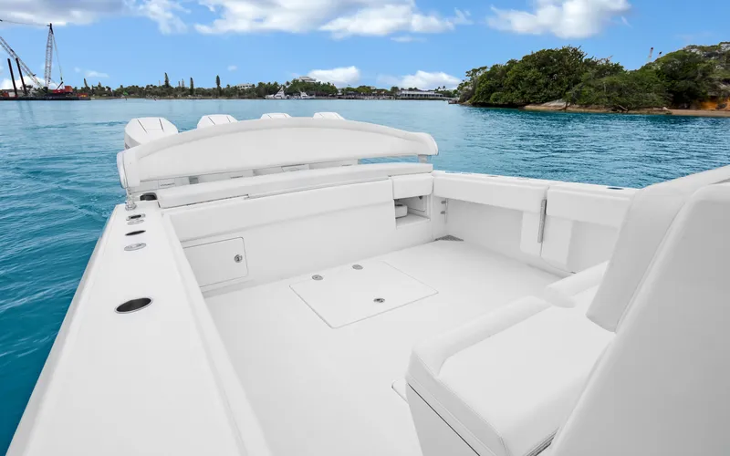 Slide: The Image of 2017 Bahama Center Console boat on clear blue water with lush green shoreline. - 27