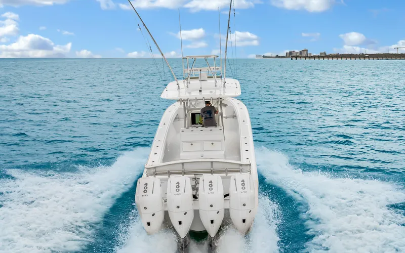 Slide: The Image of 2017 Bahama Center Console boat cruising on open water with four engines. - 3