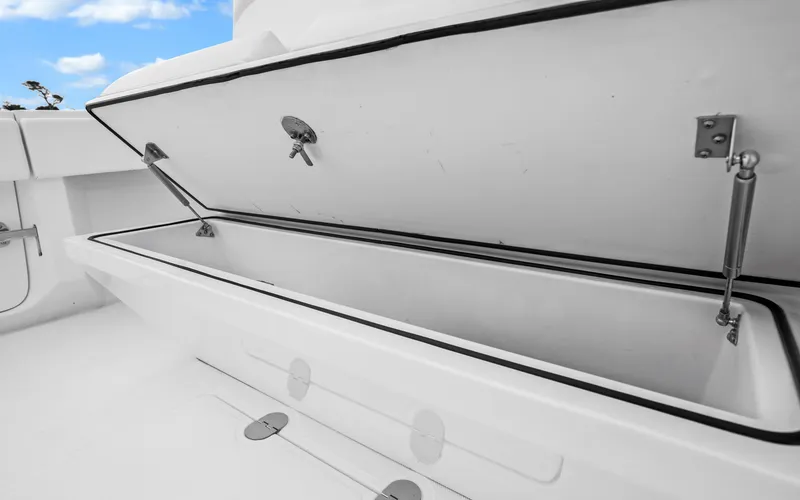Slide: The Image of Open storage compartment on 2017 Bahama Center Console boat under a blue sky. - 30