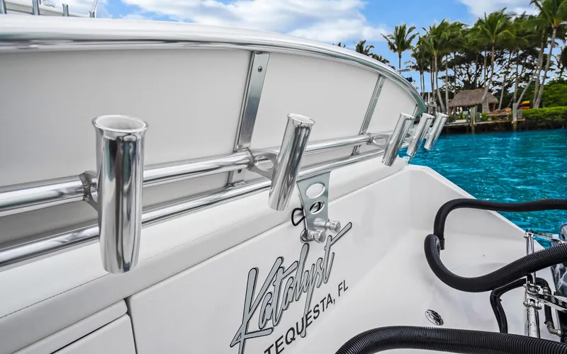 Slide: The Image of 2017 Bahama Center Console boat with rod holders, docked near tropical waters. - 31
