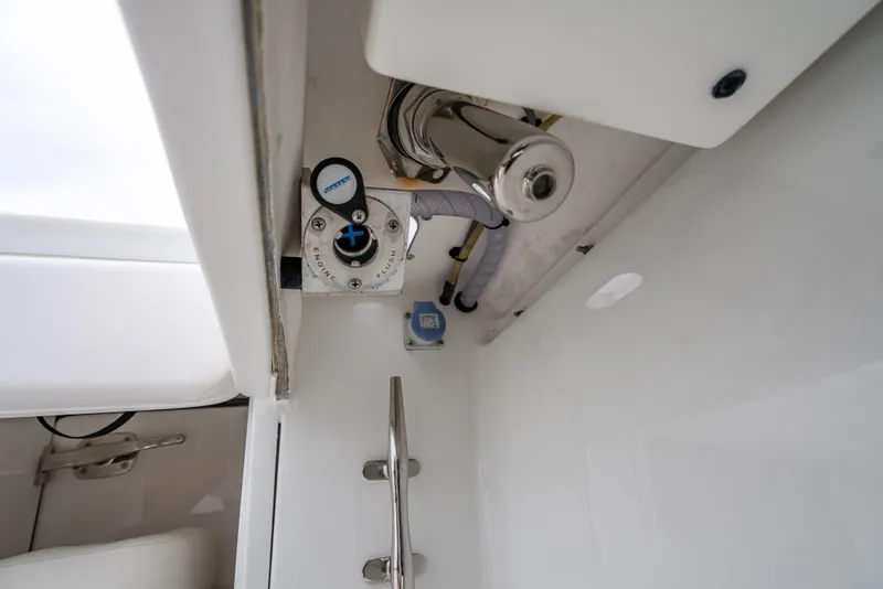 Slide: The Image of 2017 Bahama Center Console boat interior, featuring control panel and plumbing components. - 33