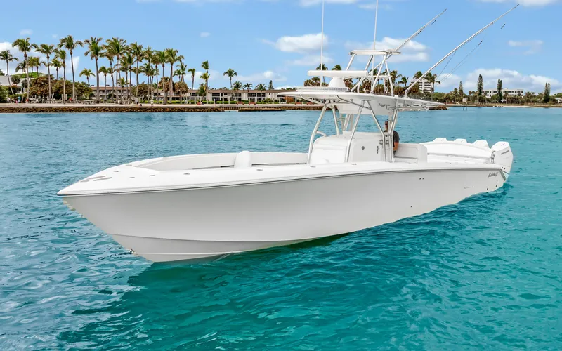 Slide: The Image of 2017 Bahama Center Console boat on turquoise water, with palm trees in the background. - 37