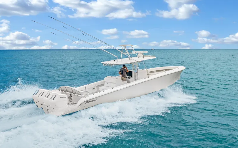 Slide: The Image of 2017 Bahama Center Console boat cruising on open ocean under a partly cloudy sky. - 43