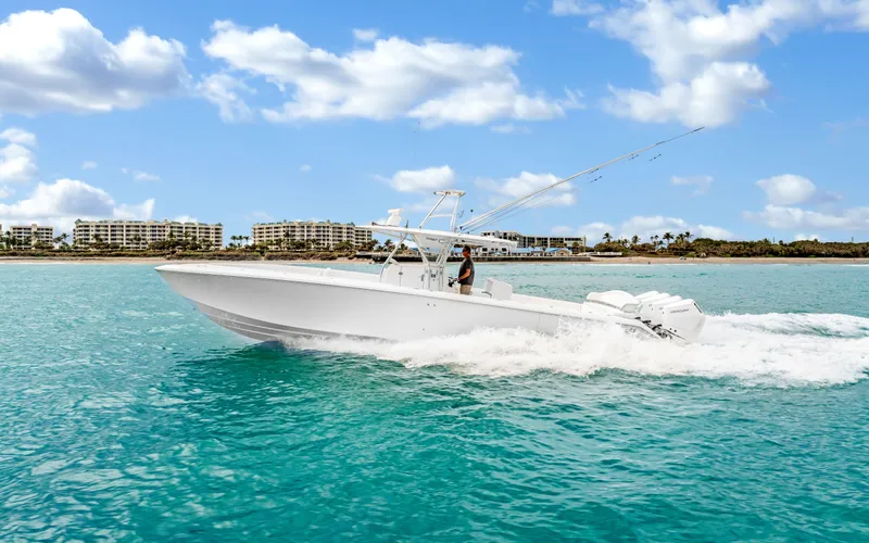 Slide: The Image of 2017 Bahama Center Console boat cruising on turquoise water under a blue sky. - 44