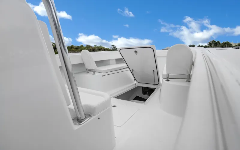 Slide: The Image of 2017 Bahama Center Console boat interior with open storage compartment under blue sky. - 7