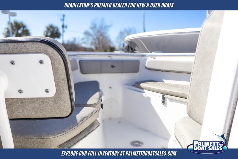 Slide: The Image of 2022 Sea Pro 259 Center Console boat interior with cushioned seating, showcased by Palmetto Boat Sales. - 21