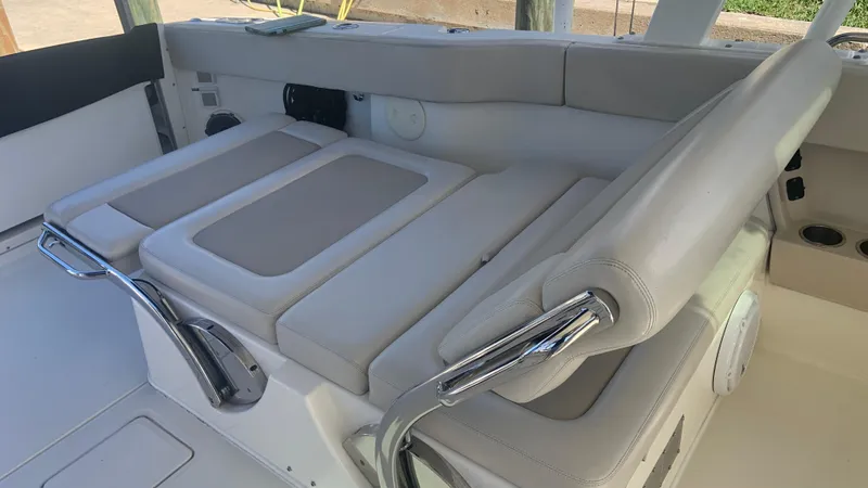 Slide: The Image of 2019 Boston Whaler 320 Vantage boat interior with beige seating and stainless steel accents. - 13