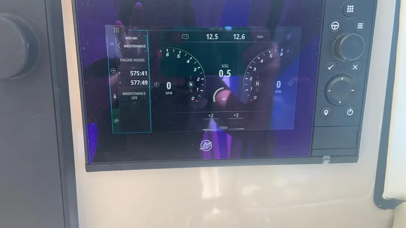 Slide: The Image of Dashboard display of a 2019 Boston Whaler 320 Vantage boat showing engine metrics. - 16