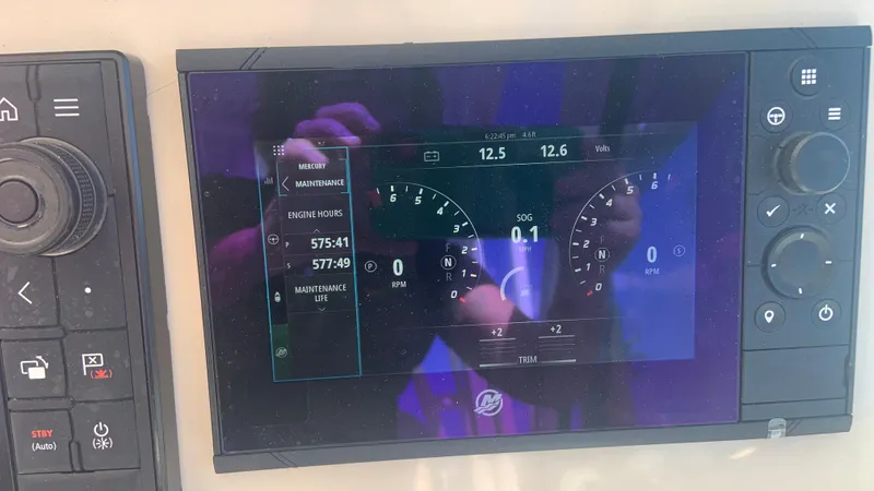 Slide: The Image of Dashboard display of a 2019 Boston Whaler 320 Vantage boat showing engine metrics. - 22