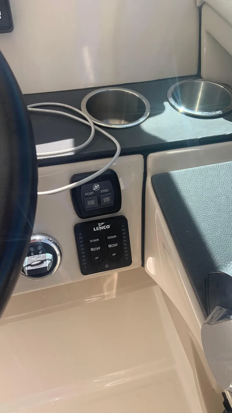 Slide: The Image of Control panel and cup holders on a 2019 Boston Whaler 320 Vantage boat. - 4