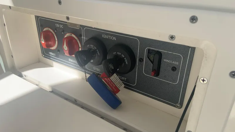 Slide: The Image of Control panel of a 2019 Boston Whaler 320 Vantage boat with ignition switches. - 8