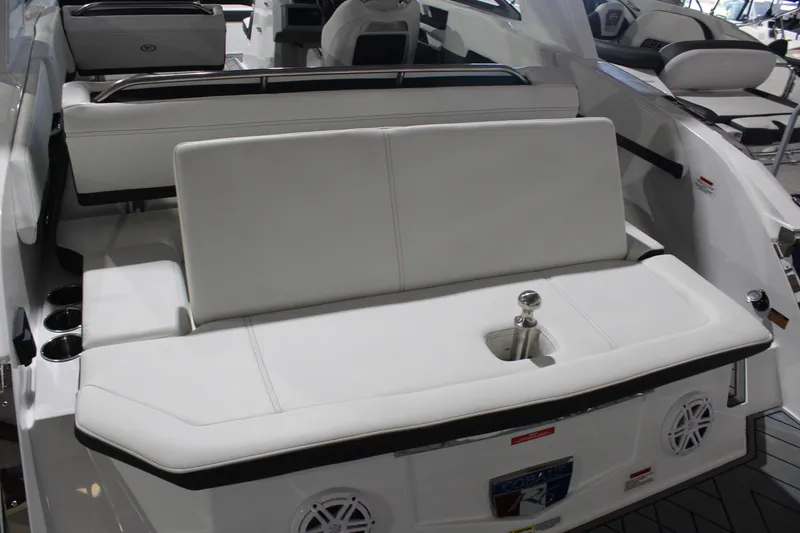 Slide: The Image of 2025 Cobalt R6 boat interior with white seating and cup holders. - 16
