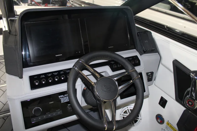 Slide: The Image of 2025 Cobalt R6 boat dashboard with modern steering wheel and dual display screens. - 22
