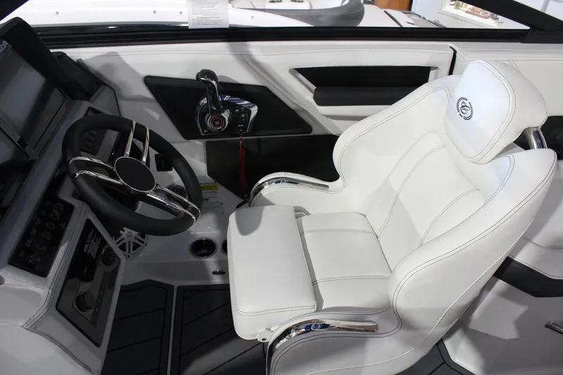 Slide: The Image of 2025 Cobalt R6 boat interior with white captain's chair and modern steering console. - 24