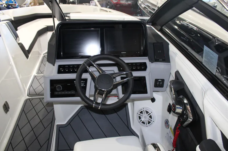Slide: The Image of 2025 Cobalt R6 boat cockpit with modern steering wheel and dual display screens. - 28