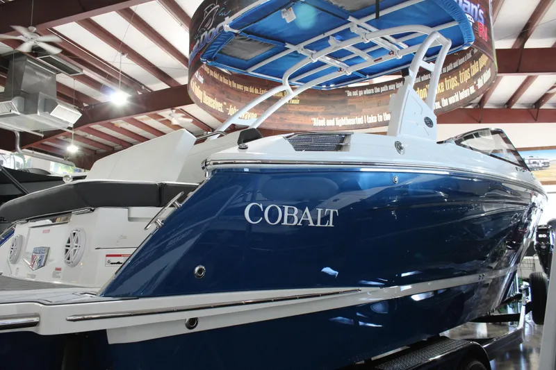 Slide: The Image of 2025 Cobalt R6 boat in showroom, blue exterior, sleek design. - 5