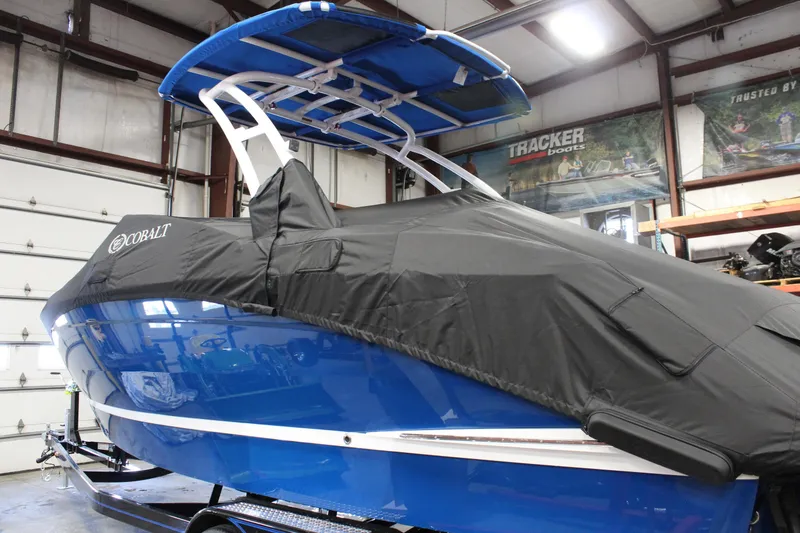 Slide: The Image of 2025 Cobalt R6 boat with cover in a garage setting. - 9