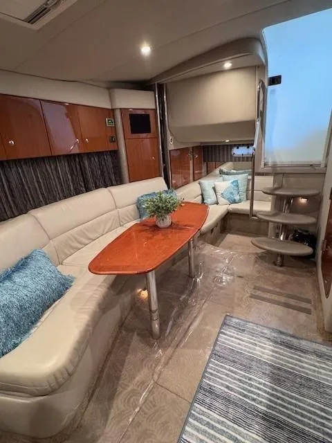 Slide: The Image of 2006 Formula 34 PC yacht interior with plush seating, wooden table, and modern decor. - 10