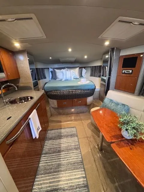 Slide: The Image of Interior of a 2006 Formula 34 PC yacht with modern amenities and cozy sleeping area. - 12
