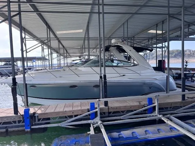 Slide: The Image of 2006 Formula 34 PC boat docked in a covered marina, side view. - 16