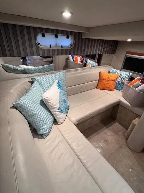 Slide: The Image of 2006 Formula 34 PC yacht interior with plush seating and decorative pillows. - 9