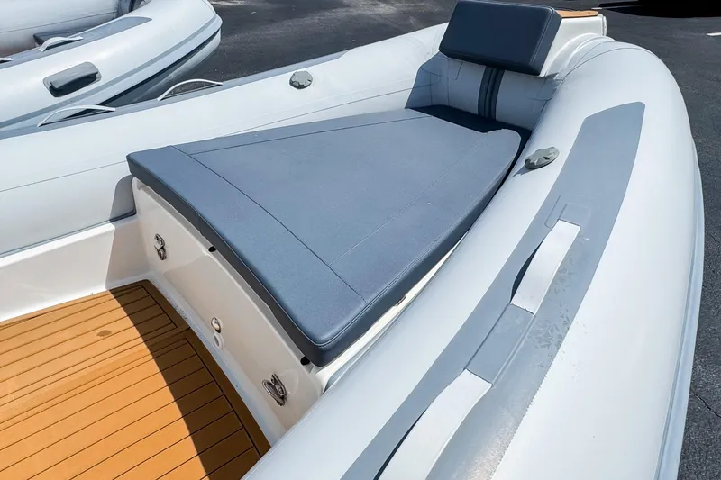 Slide: The Image of 2023 Northstar Axis 4.8 inflatable boat with cushioned seating and teak-style flooring. - 12