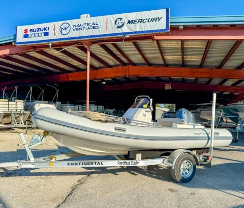 Slide: The Image of 2023 Northstar Axis 4.8 RIB boat on trailer at dealership. - 9