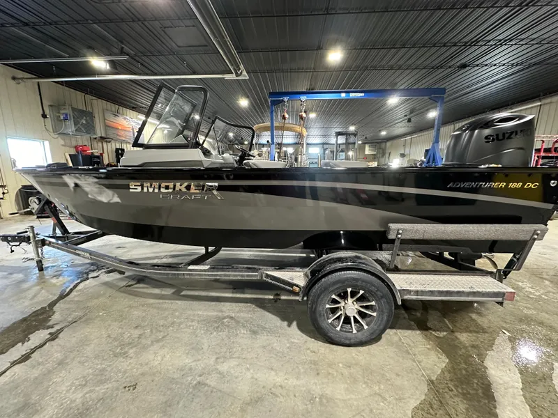 The Image of 2025 Smoker Craft Adventurer 188 DC boat on trailer in indoor garage. - 0
