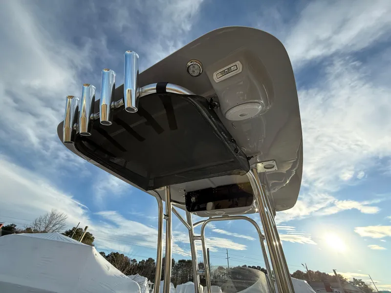 Slide: The Image of 2025 Key West 230 Bay Reef boat with T-top against a bright sky. - 15