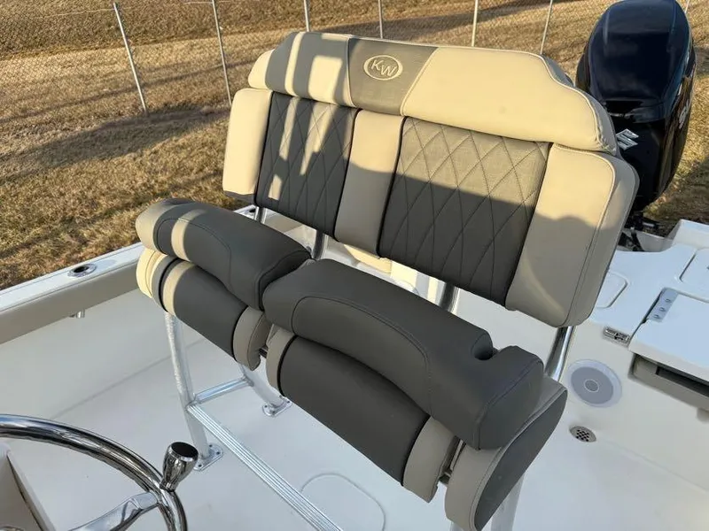 Slide: The Image of 2025 Key West 230 Bay Reef boat seat with diamond-stitched upholstery and steering wheel. - 16