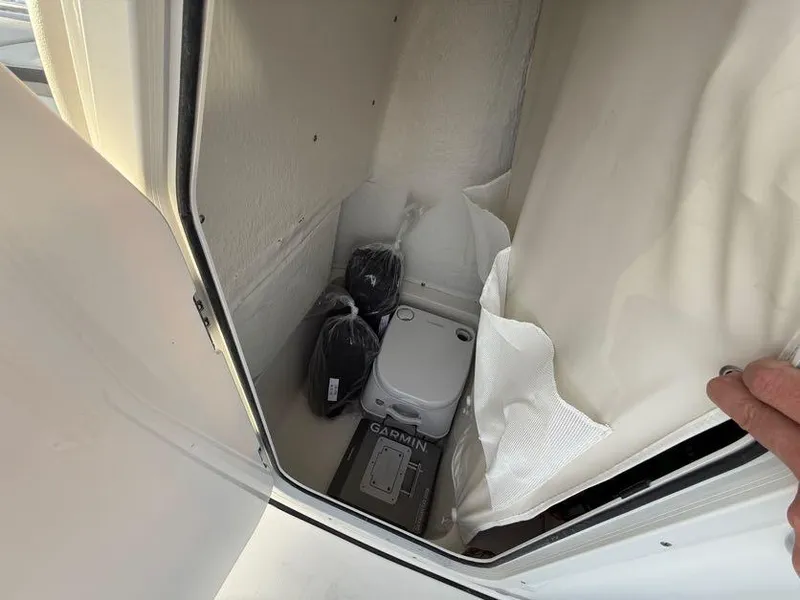 Slide: The Image of Storage compartment in 2025 Key West 230 Bay Reef boat with Garmin equipment. - 19