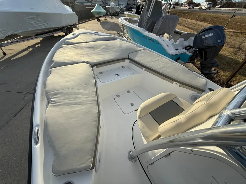 Slide: The Image of 2025 Key West 230 Bay Reef boat with cushioned seating and Yamaha outboard motor. - 21
