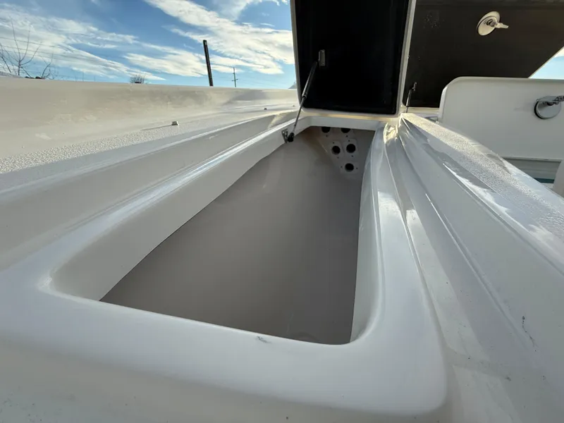 Slide: The Image of 2025 Key West 230 Bay Reef boat storage compartment under a clear blue sky. - 24