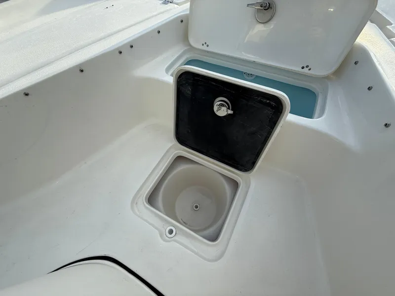 Slide: The Image of Key West 230 Bay Reef 2025 boat storage compartment with open hatch. - 26