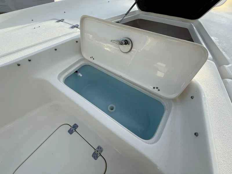 Slide: The Image of 2025 Key West 230 Bay Reef boat livewell with open lid, showcasing interior. - 27