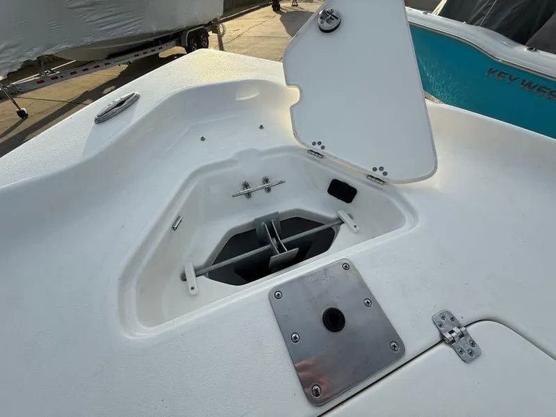 Slide: The Image of 2025 Key West 230 Bay Reef boat anchor compartment with open hatch. - 29