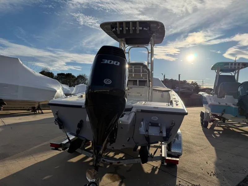 Slide: The Image of 2025 Key West 230 Bay Reef boat with 300 horsepower engine, parked outdoors. - 5