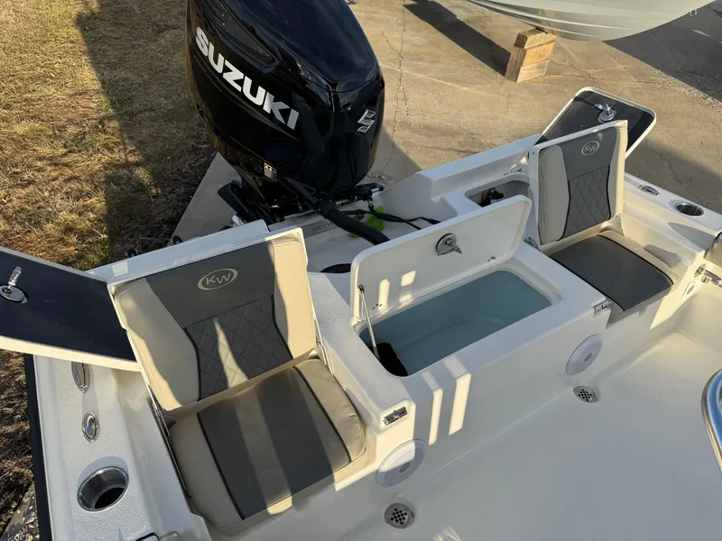 Slide: The Image of 2025 Key West 230 Bay Reef boat interior with Suzuki engine, featuring seating and storage compartments. - 9