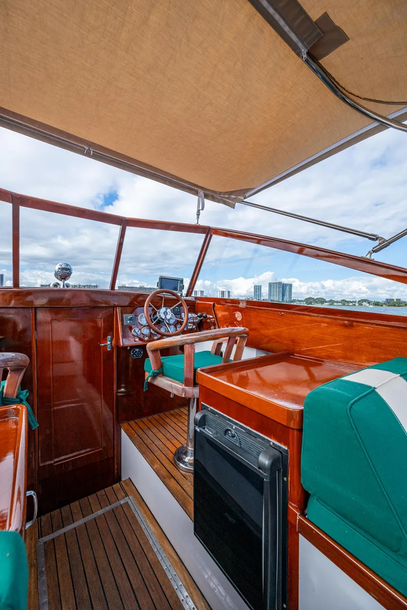 Slide: The Image of Interior view of 2010 Blackfin 28 CC boat with wooden accents and green seating. - 14