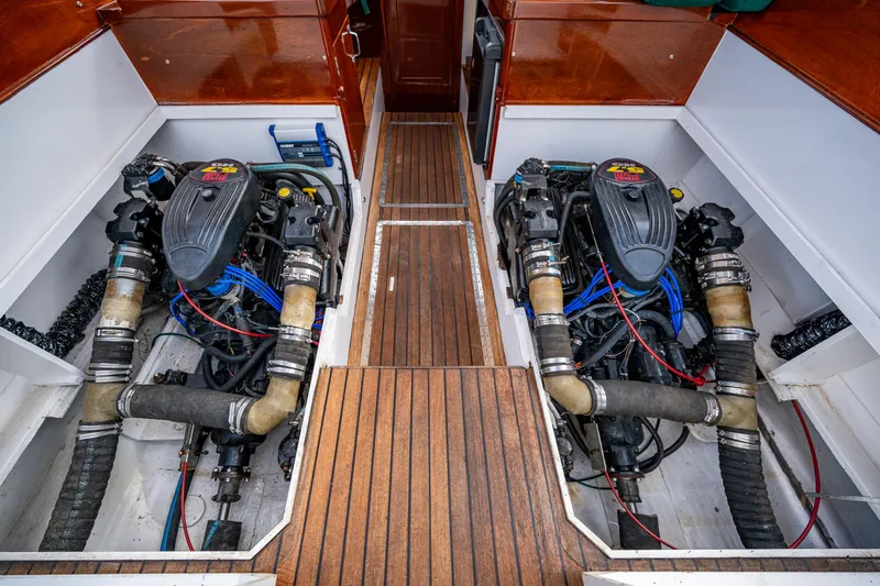 Slide: The Image of Twin engines in a 2010 Blackfin 28 CC boat, showcasing detailed engine compartment. - 4