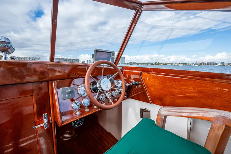 Slide: The Image of Interior of 2010 Blackfin 28 CC boat with wooden dashboard and steering wheel. - 8
