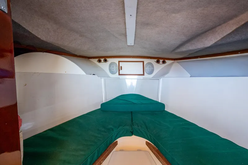 Slide: The Image of Interior cabin of 2010 Blackfin 28 CC boat with green cushions. - 10