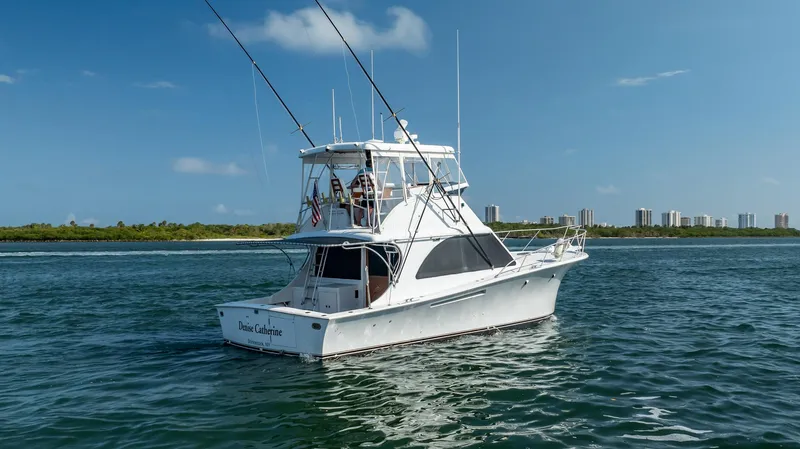 Slide: The Image of 1991 Jersey 42 Convertible Sportfisherman boat on calm water, clear sky background. - 10
