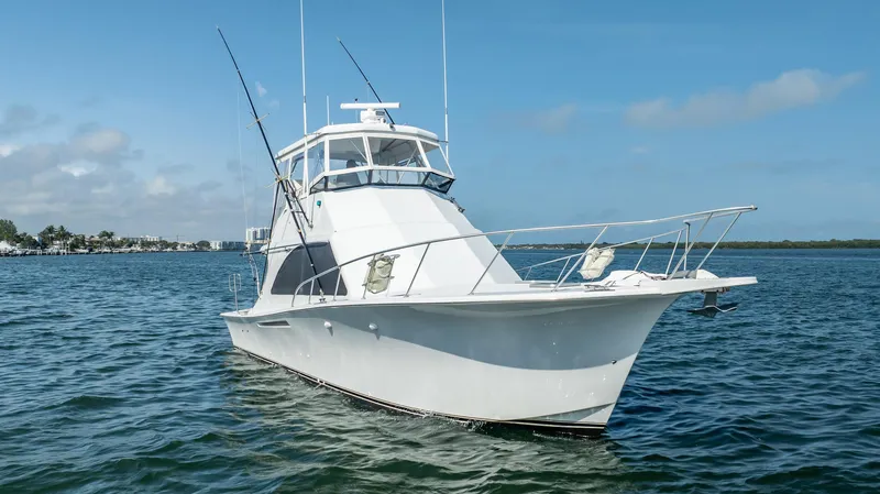 Slide: The Image of 1991 Jersey 42 Convertible Sportfisherman boat on calm water under blue sky. - 12
