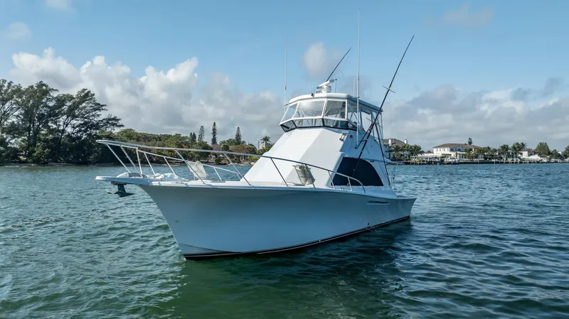 Slide: The Image of 1991 Jersey 42 Convertible Sportfisherman boat on calm water, clear sky background. - 13