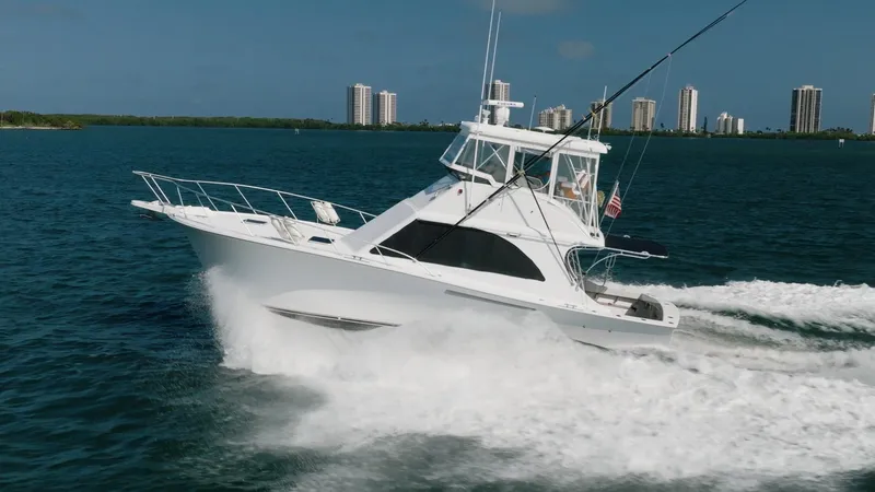 Slide: The Image of 1991 Jersey 42 Convertible Sportfisherman cruising on water with city skyline in background. - 3