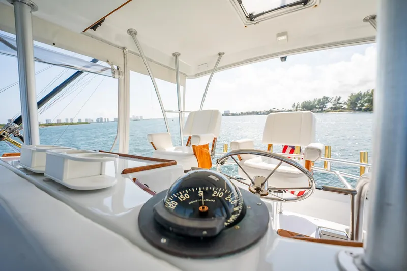 Slide: The Image of Interior view of 1991 Jersey 42 Convertible Sportfisherman yacht with steering wheel and compass. - 33