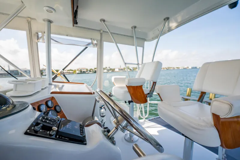Slide: The Image of Interior view of 1991 Jersey 42 Convertible Sportfisherman yacht with steering wheel and seating. - 35