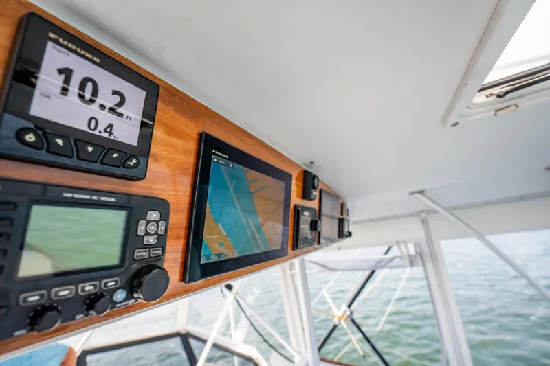 Slide: The Image of Control panel of a 1991 Jersey 42 Convertible Sportfisherman boat with navigation displays. - 37