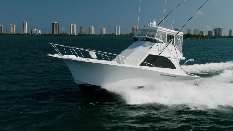 Slide: The Image of 1991 Jersey 42 Convertible Sportfisherman cruising on water with city skyline in background. - 4